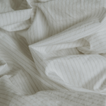 The Crisp bedsheet set - Pinstripe (Clay/Chalk) - close-up of crumbled sheets
