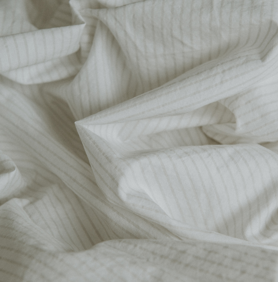 Closeup of percale cotton bedding - Pinstripe Chalk/Clay