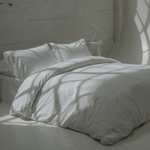 The Crisp bed bundle - Chalk - bedsheets and duvet on queen sized bed - Percale cotton
