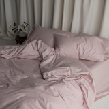 Image of soft lilac coloured messy bed