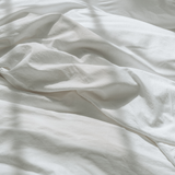 The Crisp duvet cover close-up on bed - Chalk - bedding for hot sleepers